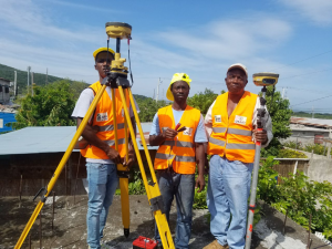 Junior land surveying technician and survey assistant, trained community members, assisting the licensed surveyor to set up GPS equipment.